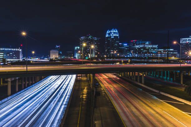 Aerial view of a modern highway interchange at dusk. Infrastructure in motion.